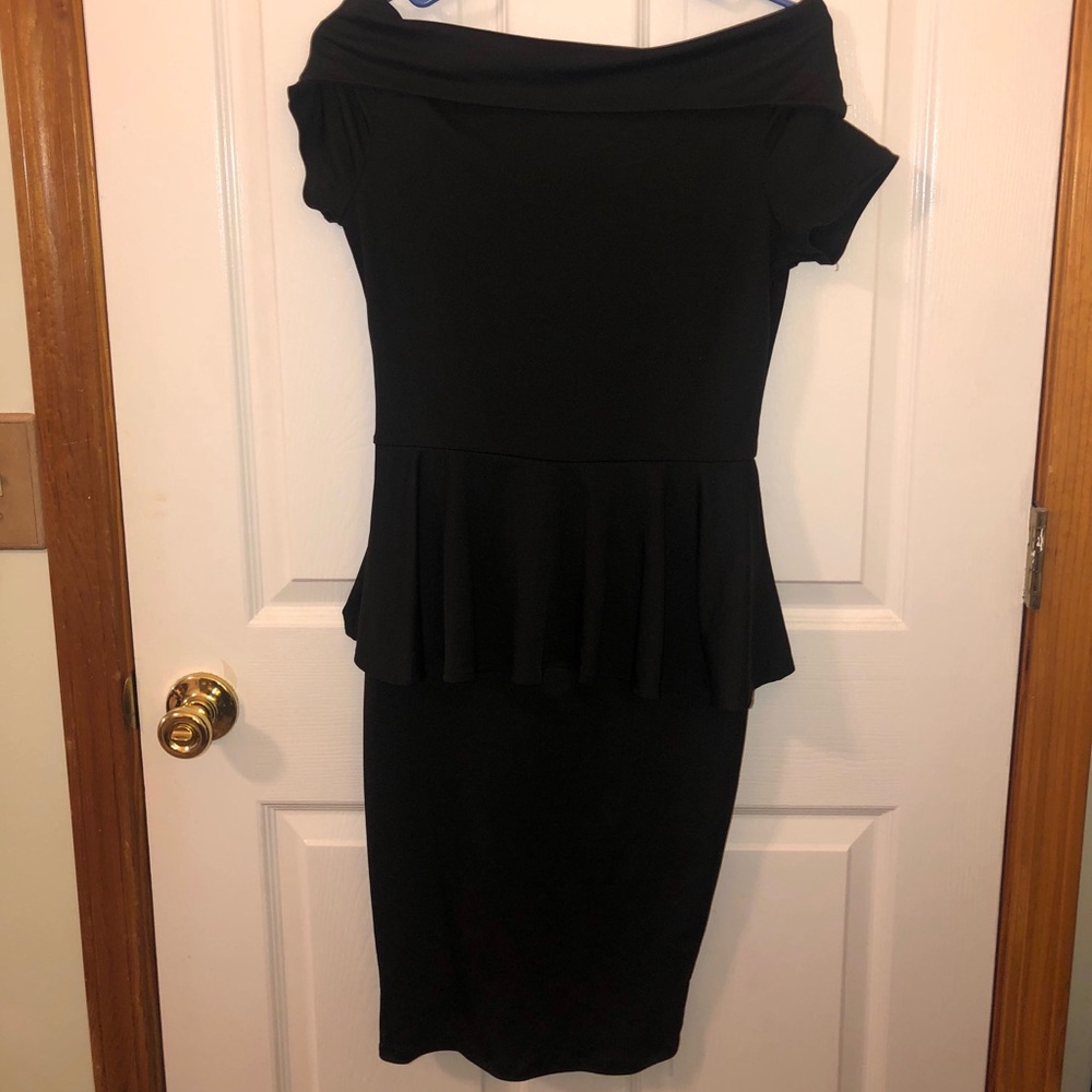 Off shoulder black dress with peplum waist.